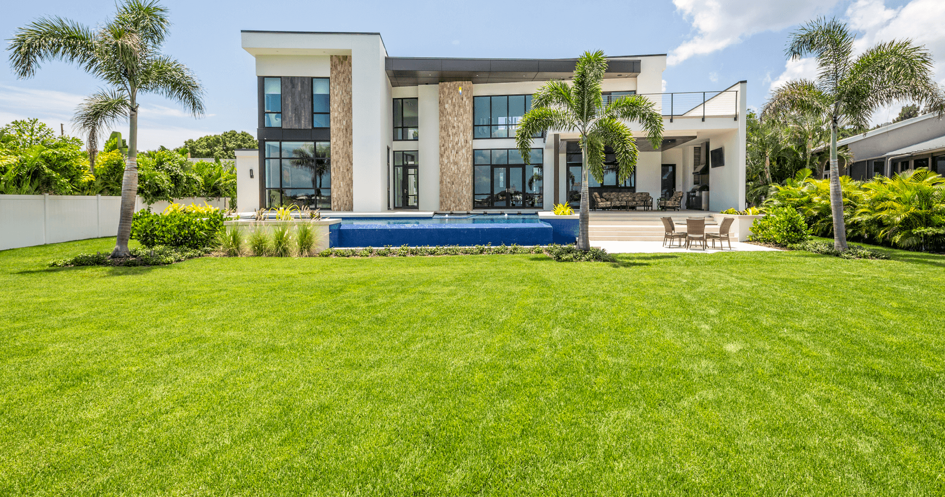 Landscaping on large space with modern home and swimming pool